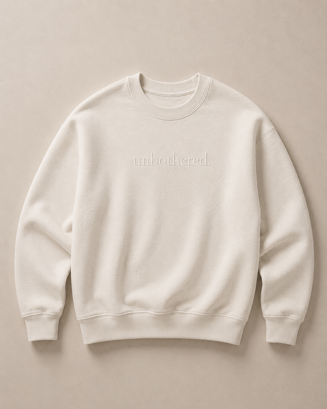 Cream sweatshirt with 'unbothered' text in cream serif